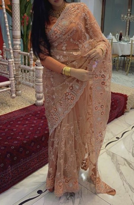 Coral saree with satin burnt orange blouse and petty coat